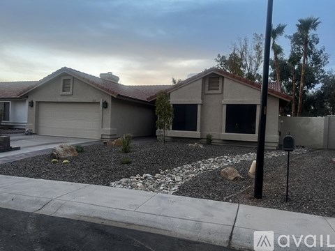 A house with a garage and a driveway in front.