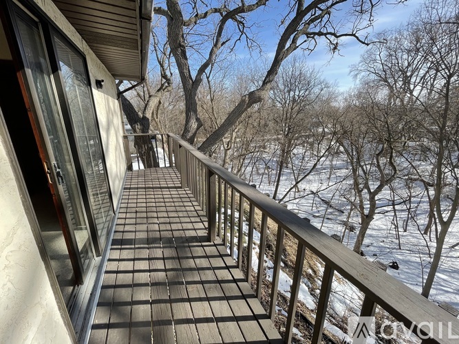 A balcony with a view of snow-covered trees.