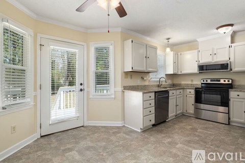 A kitchen with a white oven and cabinets.