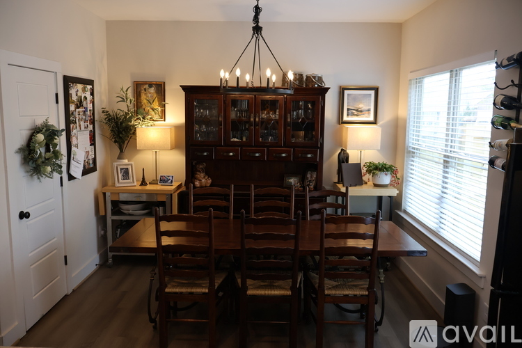 A dining room with a wooden table and chairs.