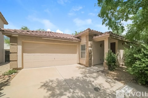 A house with a garage and a driveway is for sale.