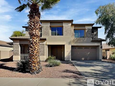 A house with a palm tree in front.