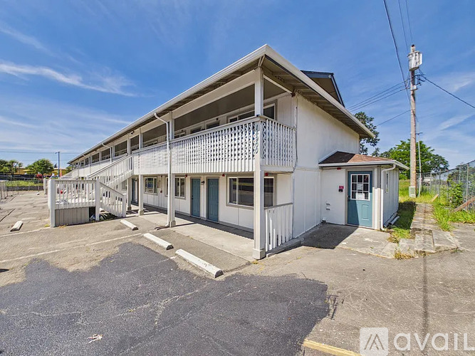 A two-story building with a balcony is available for rent.
