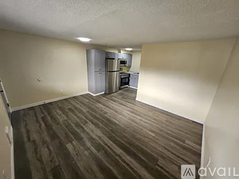 A kitchen area with a refrigerator, microwave, and oven.