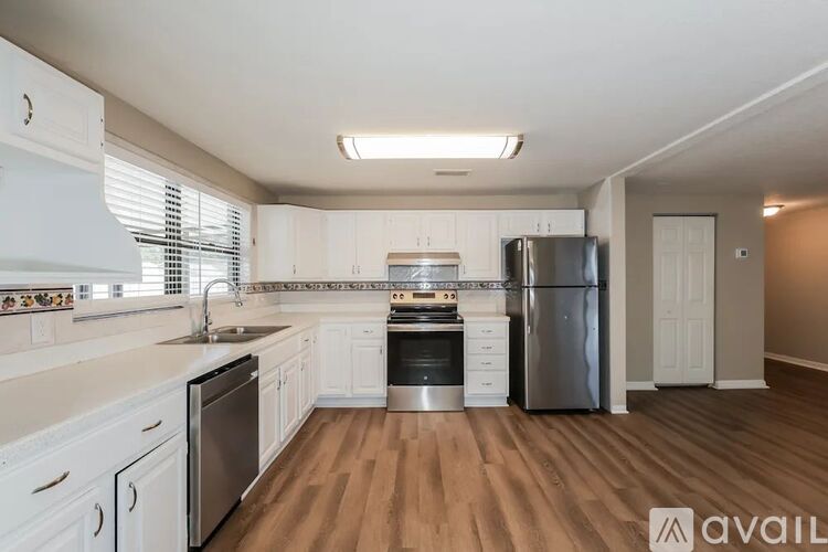 A kitchen with white cabinets and stainless steel appliances.