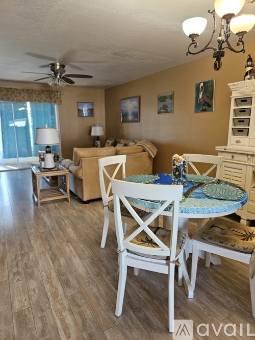A dining room with a table set for four.