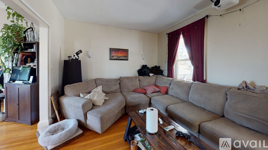 A living room with a grey couch and a white armchair.