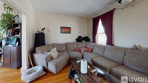 A living room with a grey couch and a white armchair.