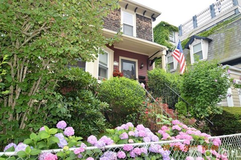 A house with a flag on the front porch.