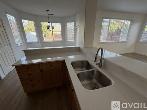 A kitchen with a sink and a window.
