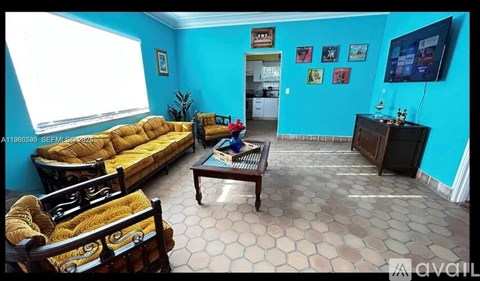 A living room with a yellow sofa and a coffee table.