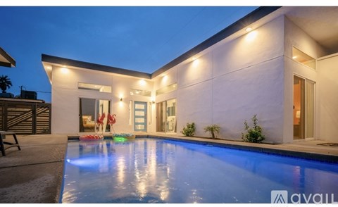 A modern house with a pool in the backyard.