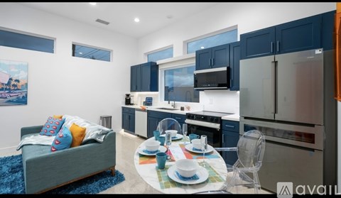 A modern kitchen with a dining table set for two.