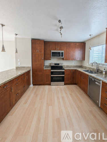A kitchen with wooden cabinets and a countertop.