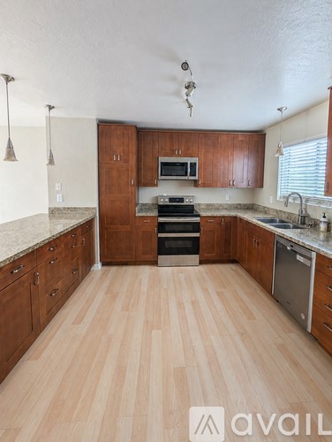A kitchen with wooden cabinets and a countertop.