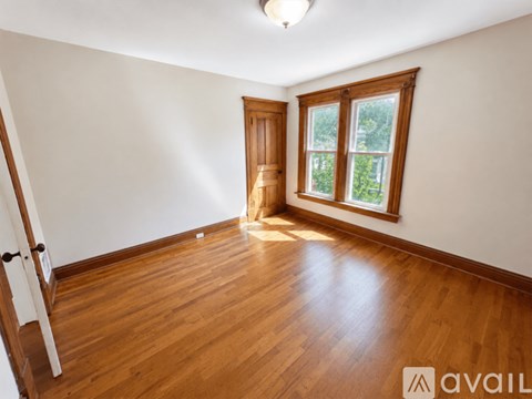 A room with wooden floors and a window.