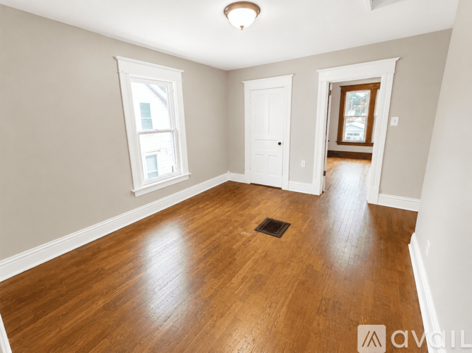 A room with wooden floors and white walls.
