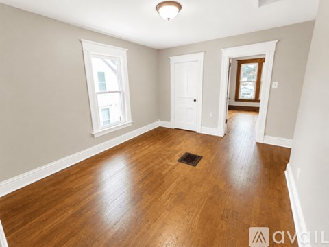 A room with wooden floors and white walls.