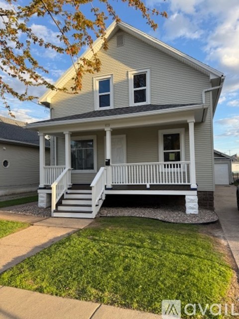 A house with a front porch and a front yard.