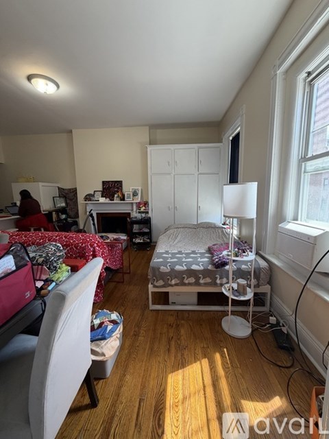 A room with a bed, desk, and chair.