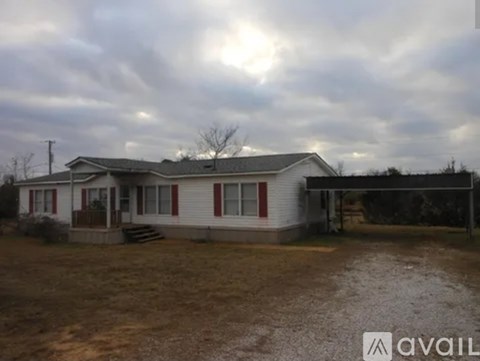 A house with a white exterior and a red door is available for purchase.
