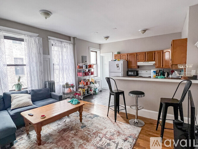 A living room with a couch, a table, and a bar area.