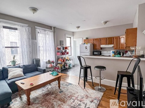 A living room with a couch, a table, and a bar area.