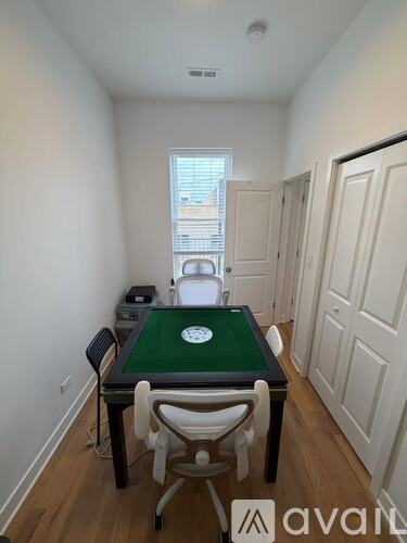 A room with a pool table and a chair.