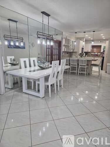 A dining room with a glass table and chairs.