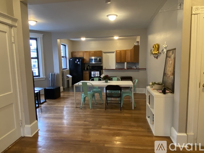 A kitchen with a table and chairs in the middle of the room.