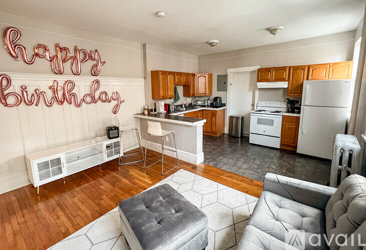 A kitchen with a Happy Birthday sign on the wall.