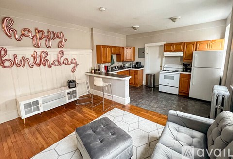 A kitchen with a Happy Birthday sign on the wall.