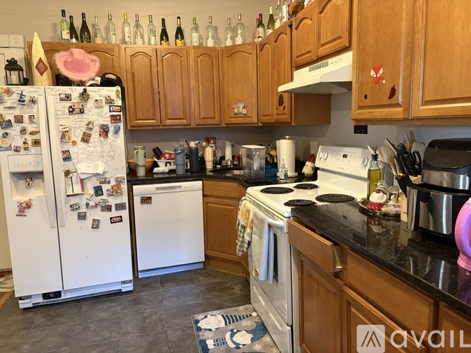 A kitchen with a white fridge and a white stove.