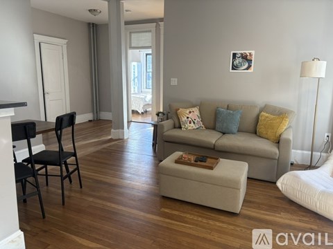 A living room with a grey couch and a coffee table.