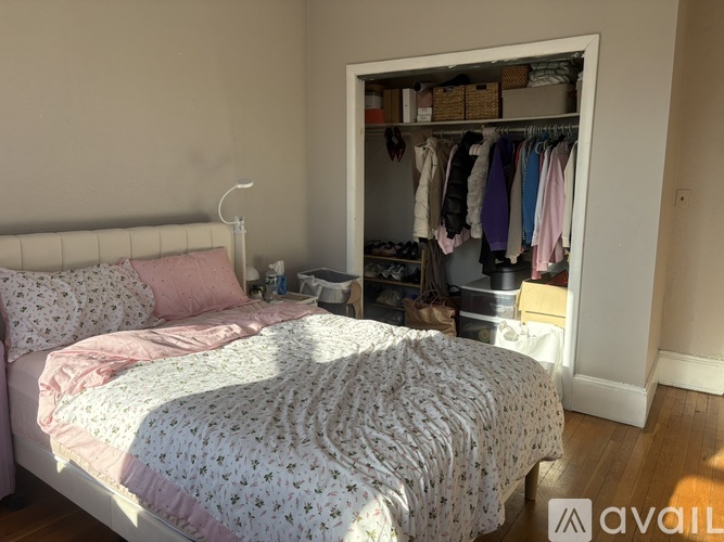 A bedroom with a bed and a wardrobe.