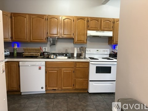 A kitchen with wooden cabinets and white appliances.