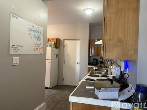 A whiteboard with the words "Teams & Recycling" written on it is in a kitchen.
