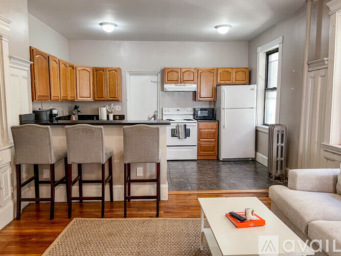 A kitchen with wooden cabinets and a white refrigerator.