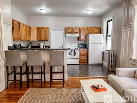 A kitchen with wooden cabinets and a white refrigerator.