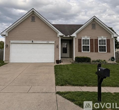 A house with a brown siding and a white garage door is for sale.