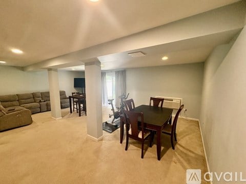 A living room with a dining table and chairs.