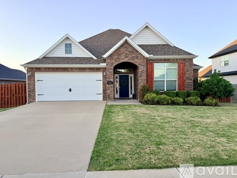 A house with a garage and a driveway is available for sale.