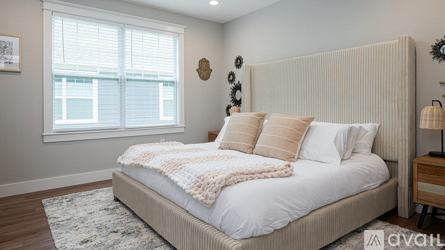 A bedroom with a large bed and a window.
