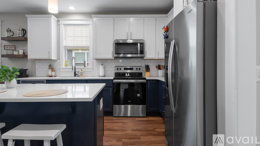 A modern kitchen with a refrigerator on the right.