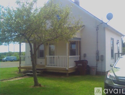 A house with a tree in front of it.