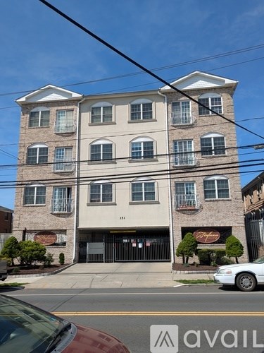 A multi-story building with a car parked in front.