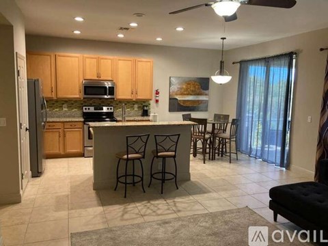 A kitchen with a bar area and a dining table.
