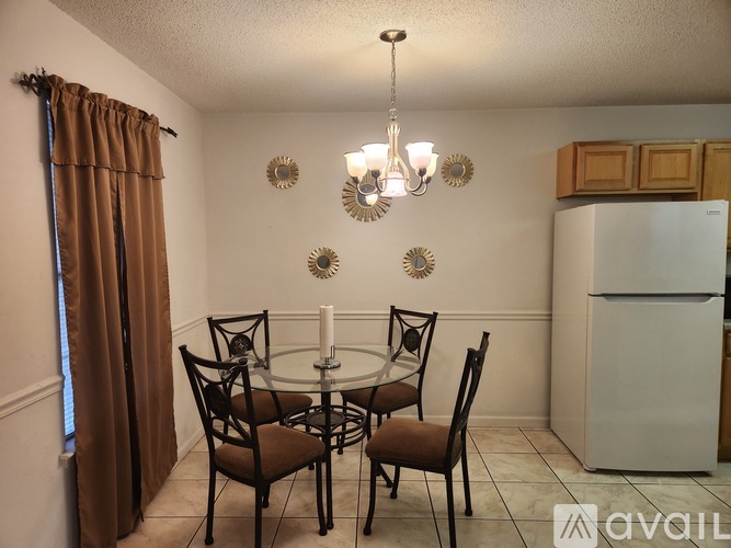 A dining room with a table set for four.