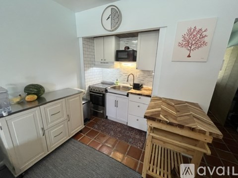 A kitchen with a wooden table and a fridge.