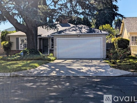 A house with a white garage door is for sale.